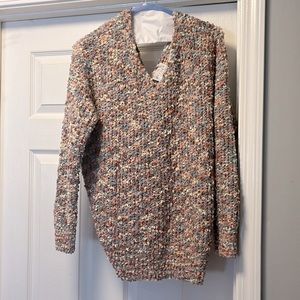 Small, boutique popcorn, criss cross back, sweater.